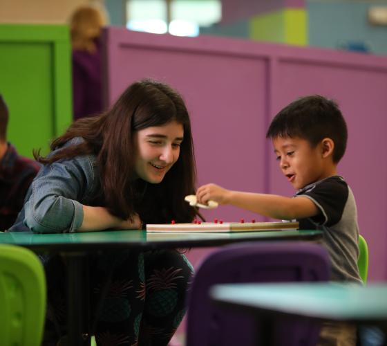 dream-center-vso Girl working on a puzzle with a young boy