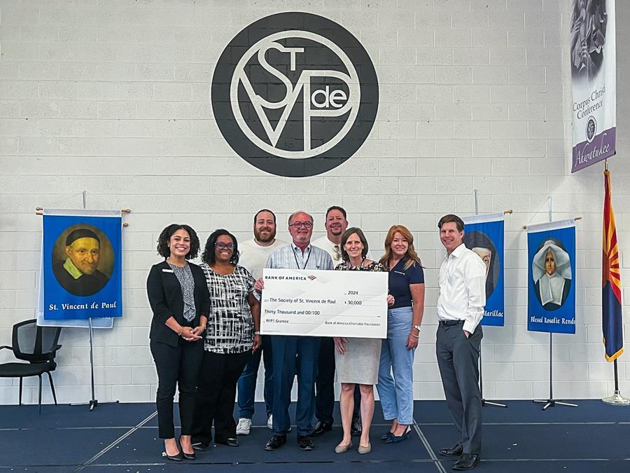 Representatives from Bank of America stand with a SVdP representative as they present a check for $30,000 for SVdP's Homelessness Prevention program.